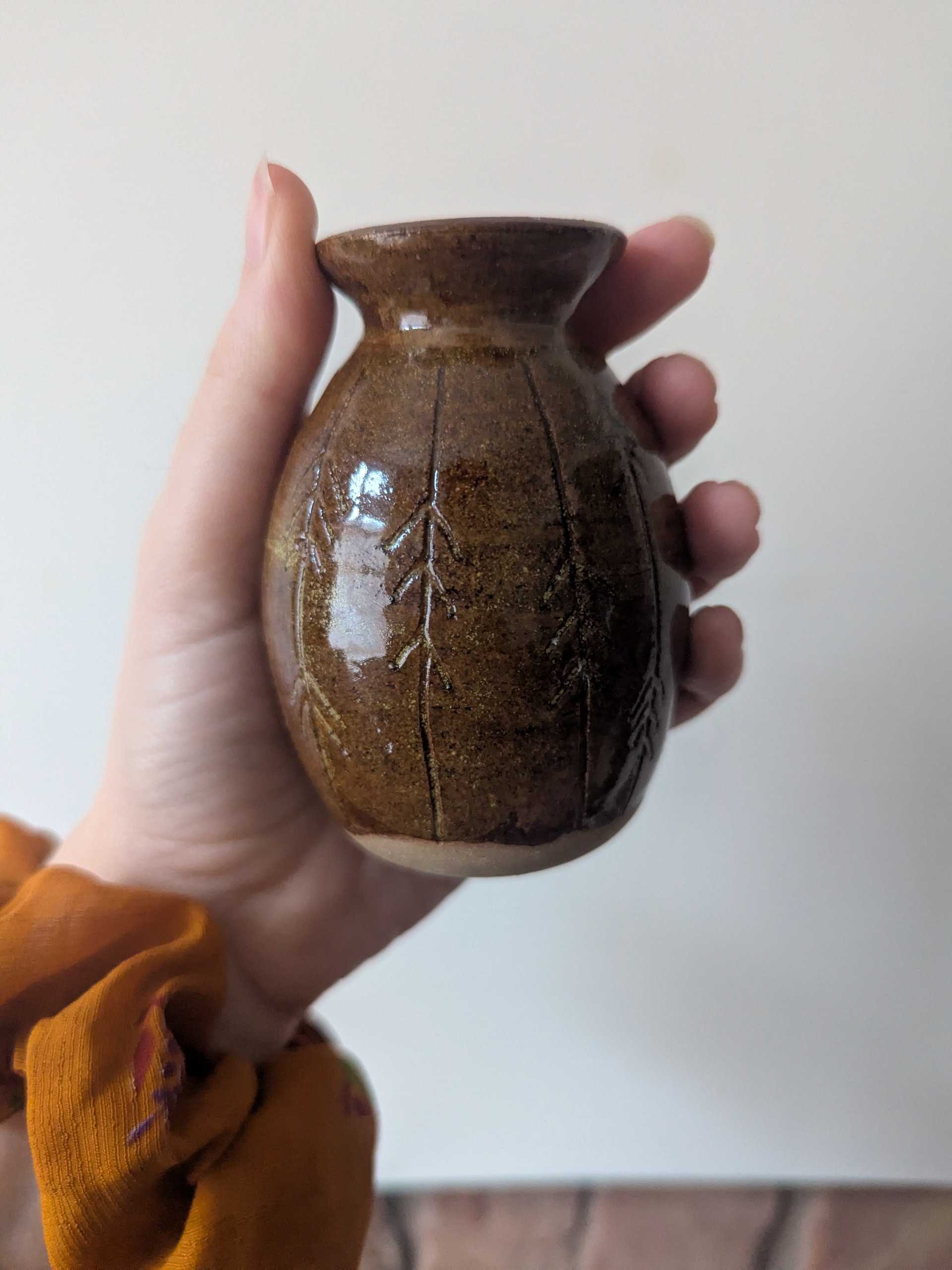 Small brown stoneware vase with carved vertical lines